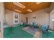 The outdoor covered patio has ample seating, with green carpet, a wooden ceiling, and relaxing views of the yard at 31 Irene Ct, Broomfield, CO 80020