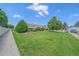 Expansive front lawn with mature trees and landscaping, showcasing the home's curb appeal at 31 Irene Ct, Broomfield, CO 80020