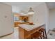 The kitchen features wooden cabinets, barstool seating at the island, and natural light from a window at 31 Irene Ct, Broomfield, CO 80020