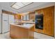 Well-lit kitchen showcases wood cabinets, modern appliances, and a functional island with cooktop at 31 Irene Ct, Broomfield, CO 80020