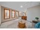 Spacious living area with neutral tones, large windows, and an open layout connecting the living space to the kitchen at 31 Irene Ct, Broomfield, CO 80020