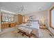 Spacious main bedroom featuring a king bed, modern decor, and en-suite bathroom with large vanity and tub at 31 Irene Ct, Broomfield, CO 80020