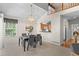 Inviting dining room with a chandelier, a pass-through bar to the kitchen, and stairway at 12502 E Harvard Cir, Aurora, CO 80014