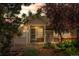 Inviting front entrance with decorative gate, mature landscaping, and charming architectural details at 12502 E Harvard Cir, Aurora, CO 80014