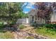 Charming home featuring a well-manicured yard, rock garden, and stylish white picket fence for added curb appeal at 12502 E Harvard Cir, Aurora, CO 80014