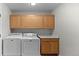 Laundry room with wood cabinets, washer, and dryer at 12502 E Harvard Cir, Aurora, CO 80014