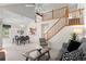 Open-concept living space featuring a dining area, living room, and staircase with ample natural light at 12502 E Harvard Cir, Aurora, CO 80014
