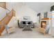Cozy living room with a fireplace, vaulted ceiling, and comfortable seating, creating a warm ambiance at 12502 E Harvard Cir, Aurora, CO 80014