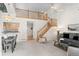 Bright and airy living room with vaulted ceilings, open staircase, and contemporary furnishings at 12502 E Harvard Cir, Aurora, CO 80014