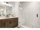 Bathroom featuring double vanity, large mirror, and spacious glass shower at 6303 Elmira St, Denver, CO 80238