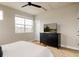 Well-lit bedroom includes a ceiling fan, a dark dresser, and wood-look floors at 6303 Elmira St, Denver, CO 80238
