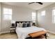 Calm bedroom with light walls, a ceiling fan, wood floors, and great natural light at 6303 Elmira St, Denver, CO 80238