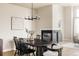 Open dining room with modern chandelier, gas fireplace, and contemporary decor at 6303 Elmira St, Denver, CO 80238
