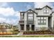 Attractive townhome with a charming covered front porch and professional landscaping at 6303 Elmira St, Denver, CO 80238