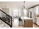 Open-concept kitchen with stainless steel appliances and a large central island at 6303 Elmira St, Denver, CO 80238