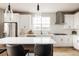 Well-lit kitchen with white cabinets, stainless steel appliances, and a spacious countertop at 6303 Elmira St, Denver, CO 80238