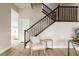 Comfortable sitting area with wooden floors adjacent to carpeted stairs at 6303 Elmira St, Denver, CO 80238