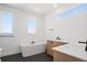 Bright bathroom with a soaking tub, dual vanities, and modern fixtures at 5584 Moosehead Cir, Longmont, CO 80504
