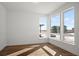 Bright bedroom with hardwood floors and three large windows offering natural light and suburban views at 5584 Moosehead Cir, Longmont, CO 80504
