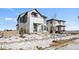 A two-story home showcasing a modern design with mixed siding, a small front porch, and snow covered yard at 5584 Moosehead Cir, Longmont, CO 80504