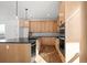 Modern kitchen featuring light wood cabinets, stainless steel appliances, and a large center island at 5584 Moosehead Cir, Longmont, CO 80504