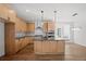 Modern kitchen featuring wood cabinets, stainless steel appliances, gray countertops, and hardwood floors at 5584 Moosehead Cir, Longmont, CO 80504