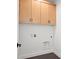 Laundry room with modern light wood cabinets for storage and hookups at 5584 Moosehead Cir, Longmont, CO 80504
