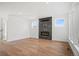 Bright living room featuring a fireplace with stone surround and large windows for natural light at 5584 Moosehead Cir, Longmont, CO 80504