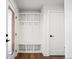 Mud room featuring white built-in storage with hooks and cubbies for organization at 5584 Moosehead Cir, Longmont, CO 80504