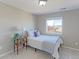 Bedroom with a cozy bed, a side table with lamp, and a view of the distant mountains through the window at 16021 Williams Pl, Broomfield, CO 80023
