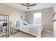 Bright bedroom featuring a ceiling fan, a sunburst mirror, and a comfortable bed with stylish decor at 16021 Williams Pl, Broomfield, CO 80023