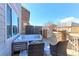 Outdoor deck with stylish furniture, a privacy screen, and a beautiful view of the surrounding neighborhood at 16021 Williams Pl, Broomfield, CO 80023