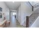Inviting hallway with wood floors, staircase with decorative iron railing, and plenty of natural light at 16021 Williams Pl, Broomfield, CO 80023