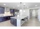 Beautiful kitchen with large granite island with barstool seating and pendant lights at 16021 Williams Pl, Broomfield, CO 80023