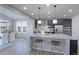 Open kitchen with granite island, pendant lighting, and barstool seating, seamlessly connecting to the dining area at 16021 Williams Pl, Broomfield, CO 80023