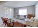 Bright and airy living room with stylish seating, large windows, and a sliding glass door leading to the patio at 16021 Williams Pl, Broomfield, CO 80023
