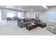Spacious living room with a large sectional sofa, a leather ottoman, and ample seating for entertaining guests at 16021 Williams Pl, Broomfield, CO 80023