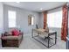 Comfortable home office featuring a large window, plush seating, and a stylish desk for a productive workspace at 16021 Williams Pl, Broomfield, CO 80023