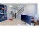 Open view from the office area with stairs, desk, and display cabinet at 16021 Williams Pl, Broomfield, CO 80023