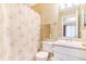 Bathroom with a vanity, toilet, and a shower with a patterned curtain, along with neutral decor at 5320 E 100Th Dr, Thornton, CO 80229