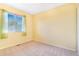 Clean and bright empty bedroom featuring a window for natural light and neutral carpeting at 5320 E 100Th Dr, Thornton, CO 80229
