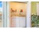 A laundry room closet features a white washer and dryer with overhead storage shelf and cleaning products at 5320 E 100Th Dr, Thornton, CO 80229