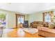 Bright and airy living room with hardwood floors, neutral walls, and an easy access to front door and dining room at 5320 E 100Th Dr, Thornton, CO 80229