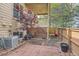 Backyard brick patio with mature trees, garden beds, lush grass, and partial fencing at 29 Woodland Cir, Highlands Ranch, CO 80126