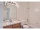 Bathroom with neutral walls, with wood vanity and full shower and bathtub combo at 29 Woodland Cir, Highlands Ranch, CO 80126