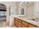 Elegant bathroom featuring double sinks, granite countertops, a walk-in shower and a window at 29 Woodland Cir, Highlands Ranch, CO 80126