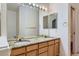 Elegant bathroom featuring double sinks, granite countertops, and ample lighting at 29 Woodland Cir, Highlands Ranch, CO 80126