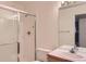 Bright bathroom featuring a glass-enclosed shower and vanity with sink and mirror at 29 Woodland Cir, Highlands Ranch, CO 80126