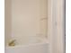 A relaxing soaking tub with gold fixtures, and a tiled platform at 29 Woodland Cir, Highlands Ranch, CO 80126
