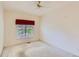 Bright bedroom featuring neutral walls, a window with tree views, and a ceiling fan at 29 Woodland Cir, Highlands Ranch, CO 80126
